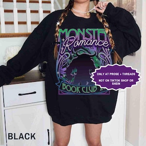 May include: Black sweatshirt with the text "Monster Romance Book Club" in a purple and green design. The sweatshirt also has a silhouette of a monster. The text "Only at Prose + Threads, Not on TikTok Shop or Shein" is also visible.
