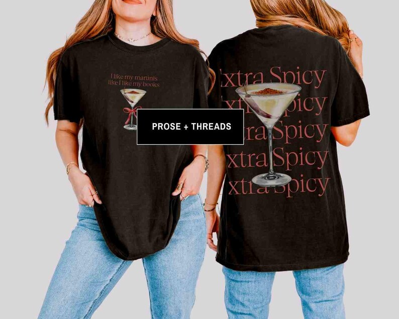 May include: Black t-shirt with a martini glass graphic and the text "I like my martinis like I like my books" on the front. The back of the shirt features a martini glass and the words "extra spicy" repeated. The brand name "PROSE + THREADS" is also visible.