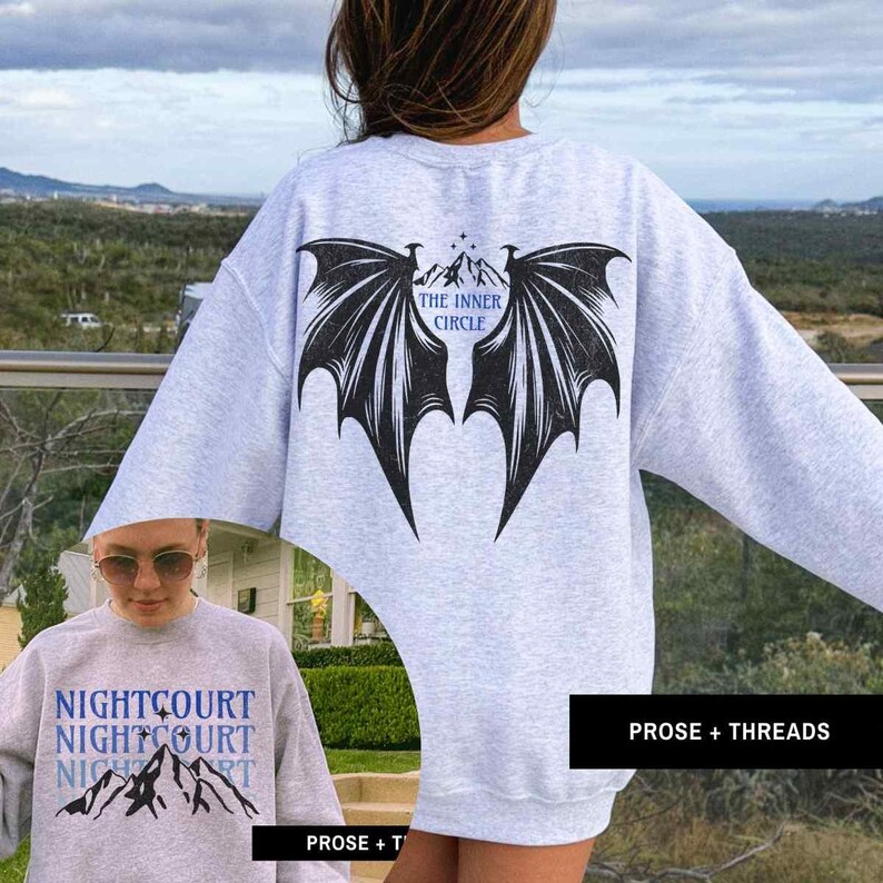 May include: A gray sweatshirt with a black bat wing design on the back. The text "The Inner Circle" is printed inside the wings. The front of the sweatshirt has the text "Nightcourt Nightcourt Nightcourt" printed in black.