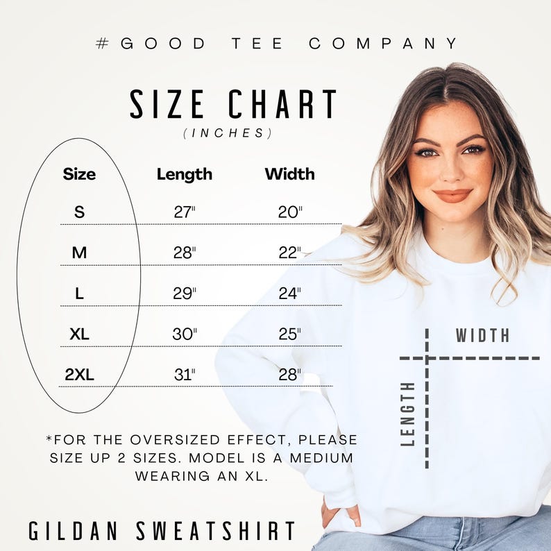 May include: A white Gildan sweatshirt with a size chart in inches. The chart shows measurements for sizes S to 2XL, with lengths from 68.58cm to 78.74cm and widths from 50.8cm to 71.12cm. The text advises sizing up for an oversized fit.
