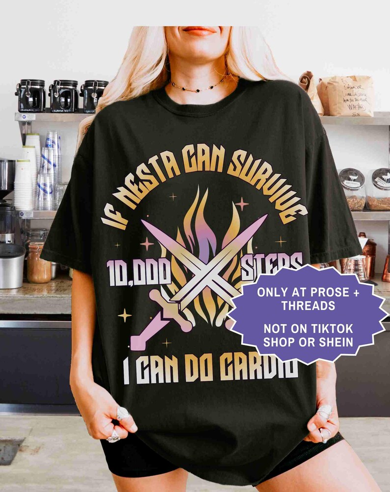 May include: Black graphic t-shirt with the text "IF NESTA CAN SURVIVE 10,000 STEPS I CAN DO CARDIO". The design includes crossed swords and a flame graphic. A purple and white sticker reads "ONLY AT PROSE + THREADS NOT ON TIKTOK SHOP OR SHEIN".