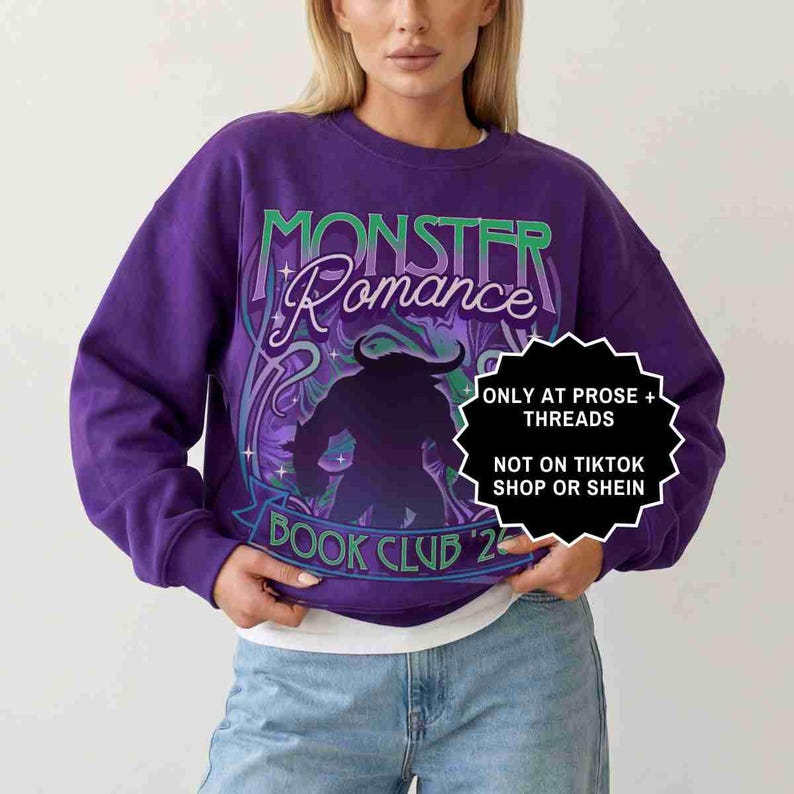 May include: A purple sweatshirt with the words "MONSTER Romance" in green and white script. Below the text is a silhouette of a monster. The words "BOOK CLUB '23" are at the bottom. A white and black sticker says "ONLY AT PROSE + THREADS NOT ON TIKTOK SHOP OR SHEIN".