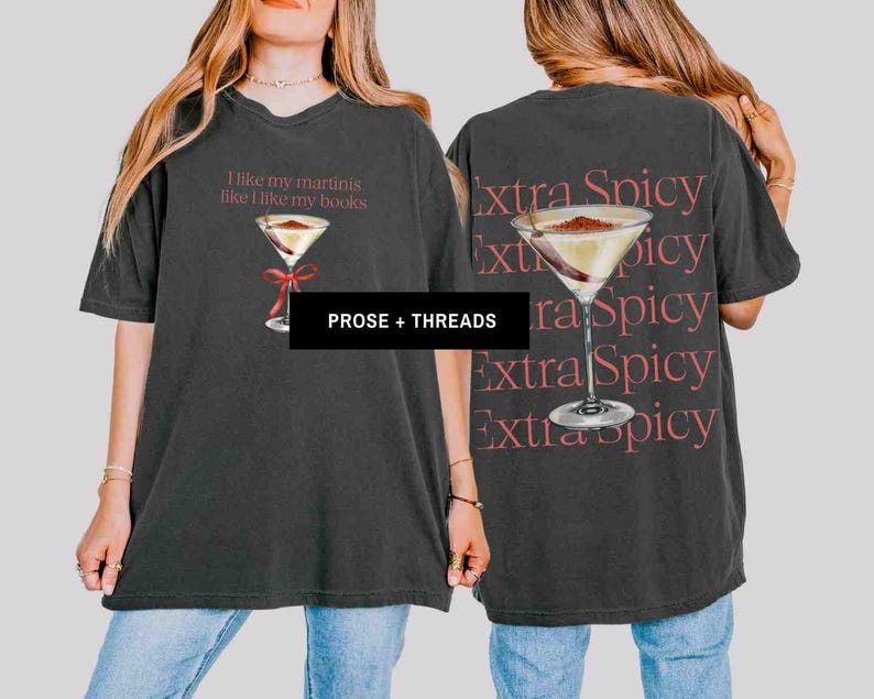 May include: Dark gray t-shirt with a martini graphic and the text "I like my martinis like I like my books" on the front. The back of the shirt features a martini graphic and the words "Extra Spicy" repeated.