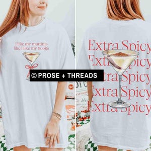 May include: White t-shirt with a martini graphic and the text "I like my martinis like I like my books" on the front. The back of the shirt features a martini graphic and the words "Extra Spicy" repeated vertically. The shirt is from Prose + Threads.