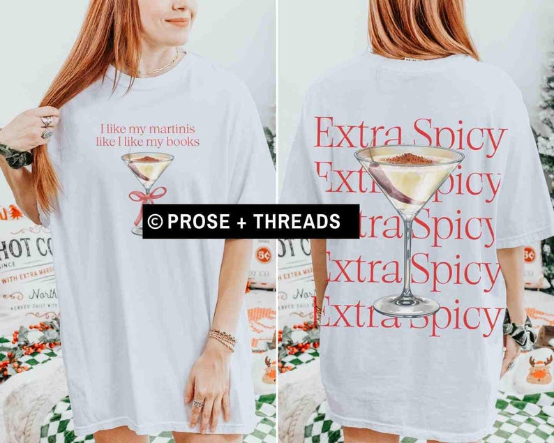 May include: White t-shirt with a martini graphic and the text "I like my martinis like I like my books" on the front. The back of the shirt features a martini graphic and the words "Extra Spicy" repeated vertically. The shirt is from Prose + Threads.