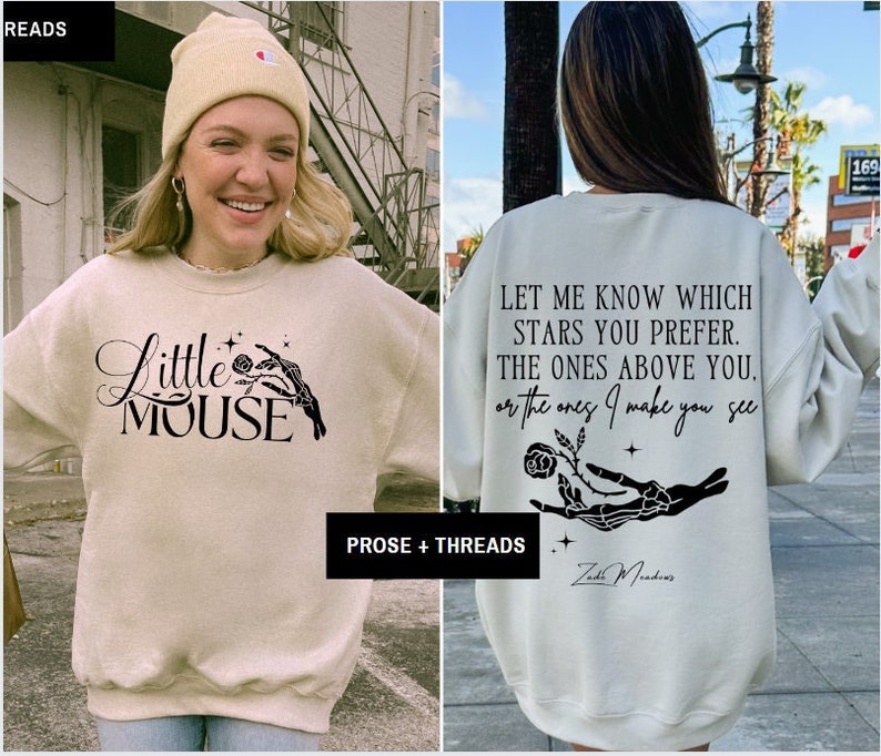 May include: A beige sweatshirt with the text "Little Mouse" and a skeleton hand holding a rose. The back of the sweatshirt features the quote "Let me know which stars you prefer..." and the author's name, Zadie Meadows.