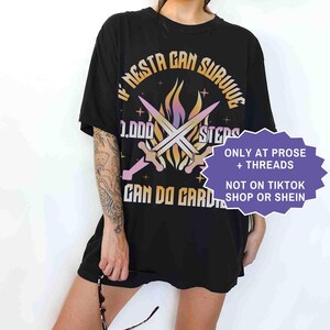 May include: Black t-shirt with the text "IF NESTA CAN SURVIVE 1,000 STEPS CAN DO GARD". The design includes crossed swords and a flame graphic. The shirt also has the text "ONLY AT PROSE + THREADS" and "NOT ON TIKTOK SHOP OR SHEIN".