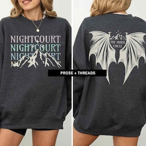 May include: A dark gray sweatshirt with the text "NIGHTCOURT NIGHTCOURT NIGHTCOURT" printed on the front and a graphic of a pair of wings with the text "THE INNER CIRCLE" printed on the back.