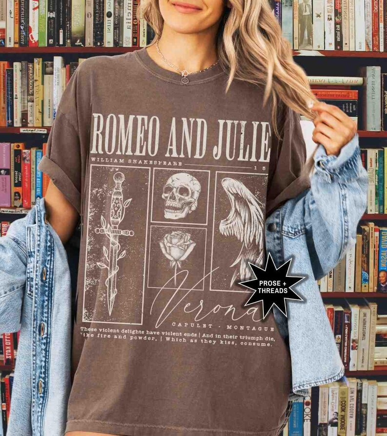 May include: Brown t-shirt featuring the text "ROMEO AND JULIE" with illustrations of a sword, skull, rose, and angel wing. The shirt also includes the text "Verona" and a quote from the play. The shirt is a vintage style.