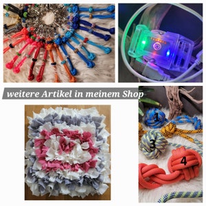 Puede incluir: Una colecci&oacute;n de juguetes para perros que incluye un juguete de cuerda anudada de colores, una cama para perros de vell&oacute;n gris y rosa, un juguete de cuerda anudada multicolor y un juguete de cuerda anudada azul y amarillo.