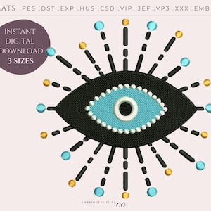 May include: A black and blue evil eye embroidery design with a white centre and a circle of white beads around the blue eye. The eye is surrounded by black lines radiating out from the eye. The design is on a white background.