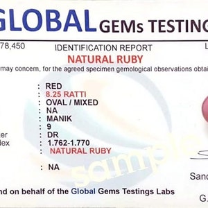 May include: A gemological report for a natural ruby gemstone. The report includes details such as color, weight, shape, cut, measurement, Hindi name, hardness, optic character, refractive index, and remarks. The report is issued by Global Gems Testings Labs and signed by Sandeep K. Bhari, Gemologist, G.C.P. (I.I.G.J.).