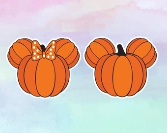 May include: Two orange pumpkins with white outlines. One pumpkin has a white bow with red polka dots on top. Both pumpkins have Mickey Mouse ears.