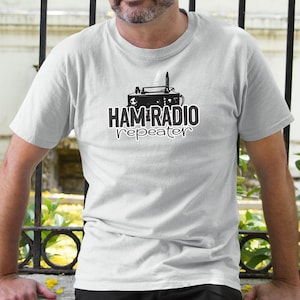 May include: A white t-shirt with a black graphic of a vintage radio and the text "HAM RADIO repeater".