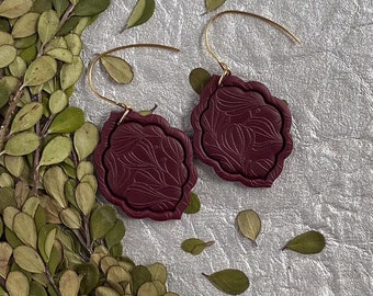 Christina Dangles burgundy red. Handmade polymer clay earrings. Embossed floral design. Unique scalloped shape. Lightweight earrings.