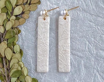 Amara Dangles pearl white. Handmade polymer clay earrings. Sleek skinny rectangle shape. Statement earrings. Embossed flowers. Pearl stud.