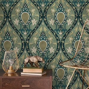 May include: A teal and green floral wallpaper with a repeating pattern of stylized flowers and leaves. A gold wire lamp, a gold bear figurine, and a gold chair are in front of the wallpaper. The wallpaper has a vintage aesthetic.