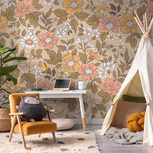May include: A room with floral wallpaper in shades of peach, orange, and white. A small desk with a laptop and lamp sits in front of the wall. A yellow chair with a stuffed animal and a small teepee are also in the room.