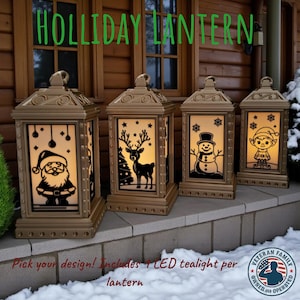 May include: Four gold-colored holiday lanterns with illuminated designs of Santa Claus, a reindeer, a snowman, and an elf. The lanterns have a classic design and are placed on a snowy surface. Text on the image reads "HOLLIDAY LANTERN".