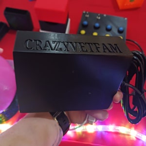 May include: A black box with the text "CRAZYVETFAM" printed on the top. The box is connected to a black cable.