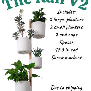 May include: The Rail V2 vertical planter system with four white planters and a wooden rod. The system includes two large planters, two small planters, end caps, a spacer, and a 44.45 cm rod. The text on the image says "The Rail V2".