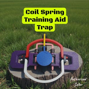 May include: A multi-colored coil spring training aid trap. The trap features a purple base, red and white arches, and a blue target. The text "Coil Spring Training Aid Trap" is displayed in a yellow box.