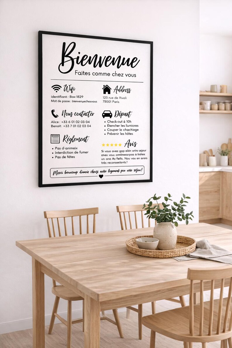 May include: A framed sign with black text in French, reading "Bienvenue" and "Faites comme chez vous." Below are details about Wi-Fi, address, contact information, rules, and departure instructions. The sign hangs above a wooden table with chairs.