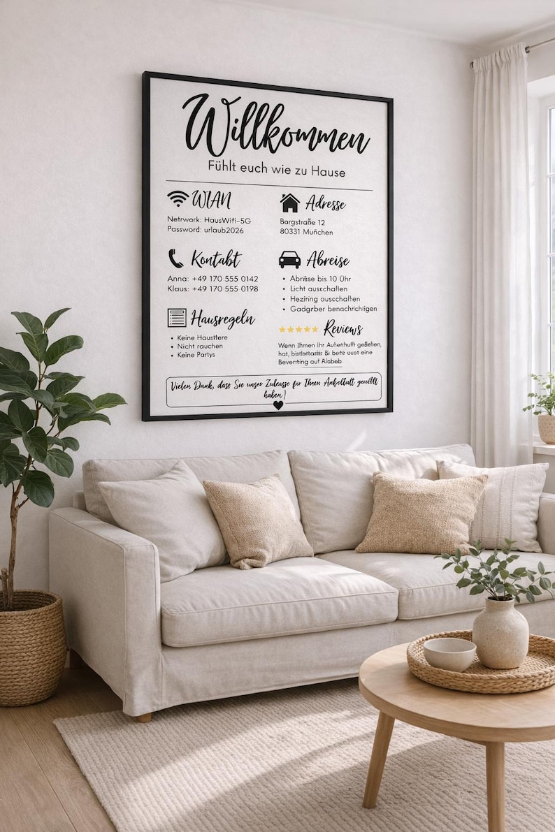 May include: A framed sign with the German word "Willkommen" in elegant script, displayed above a beige sofa with decorative pillows. The sign includes contact information, house rules, and Wi-Fi details. A small plant and a coffee table with a tray complete the scene.