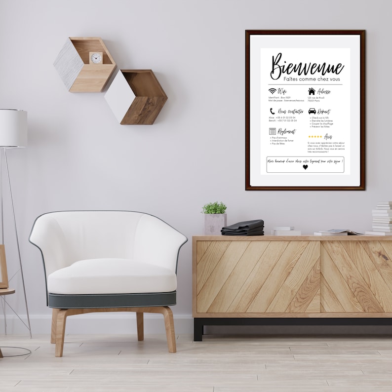 May include: A framed print with the word "Bienvenue" in elegant script. The print includes contact information, Wi-Fi details, and other guest amenities. The frame is dark brown, and the print is displayed in a modern living room setting.