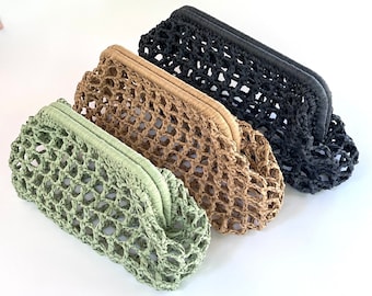 May include: Three clutch bags arranged in a row, each featuring an open-weave, net-like construction with a structured frame closure. The bags are colored in light sage green, tan, and black, showcasing a consistent design across all three items.