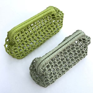 May include: Two rectangular clutch bags featuring an open-weave net construction. One bag is a vibrant lime green, while the other is a muted sage green. Both clutches have a structured, wrapped top frame closure and a consistent grid pattern.