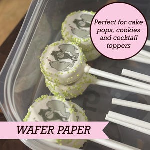 May include: Round white wafer paper toppers featuring a gray bear illustration, decorated with small lime green sprinkles on the edges. Each topper is attached to a white stick. The text reads: Perfect for cake pops, cookies and cocktail toppers.