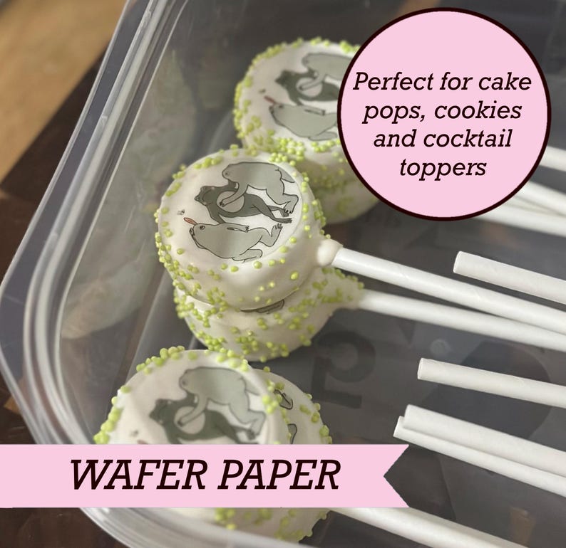 May include: Round white wafer paper toppers featuring a gray bear illustration, decorated with small lime green sprinkles on the edges. Each topper is attached to a white stick. The text reads: Perfect for cake pops, cookies and cocktail toppers.