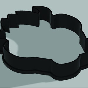 Puede incluir: Cortador de galletas de pl&aacute;stico negro con forma de cabeza de oso.