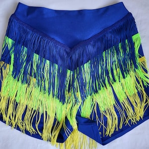 May include: Blue shorts with a yellow and green fringe trim. The shorts are made of a stretchy fabric and have a high waist.