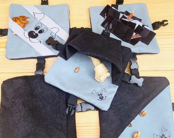 May include: Four blue and black dog treat puzzle toys with different compartments and textures. The toys are designed to engage dogs and provide mental stimulation.