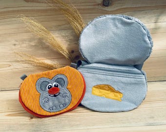 May include: A gray and orange plush toy shaped like a mouse with a red nose. The toy is attached to a gray plush bag with a zipper. The bag has a gray felt cheese patch on the front.