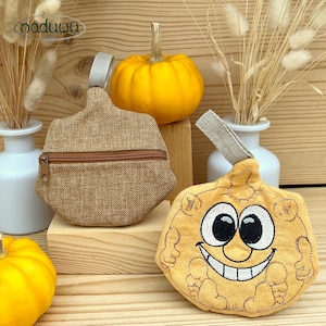 May include: Two pumpkin-shaped pouches, one in tan burlap with a zipper, and another in yellow plush with an embroidered face. A small yellow pumpkin and decorative plants are in the background. The brand name "naduuu" is in the top left corner.