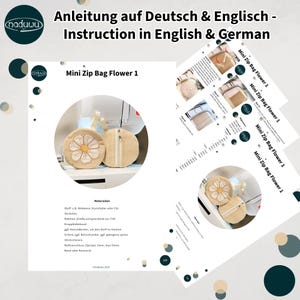 May include: Image of a sewing project with instructions in English and German. The project is a Mini Zip Bag Flower 1, featuring a beige circular pouch with a daisy design and a zipper. The image includes several pages of instructions.