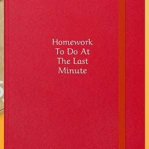 May include: Red hardcover notebook with a bright orange ribbon bookmark. The notebook has the text "Homework To Do At The Last Minute" printed on the front.