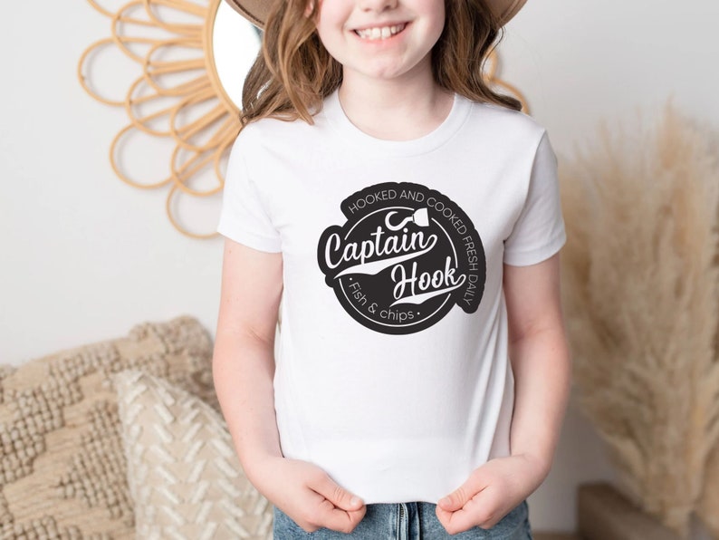 May include: White t-shirt with a black and white logo that says "Captain Hook" and "Hooked and Cooked Fresh Daily Fish & Chips".