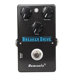 May include: Black guitar effects pedal with the text "BREAKER DRIVE" in blue lettering. The pedal has three knobs labeled "Gain", "Tone", and "Volume".