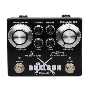 May include: Black dual guitar pedal with the text "The Dualgun Demonfx" and knobs labelled "Heavy-Hand", "Volume", "Tone", "Drive-A", "Drive-B", "String-Singer", "Fat Stock Glass", and "Bypass".