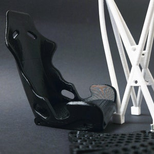 Transform your workspace with this incredible customizable DIY racing seat phone holder kit. It features an unassembled roll cage design that allows you to create a unique and stylish phone stand for your desk. Elevate your workspace today! Nine3D