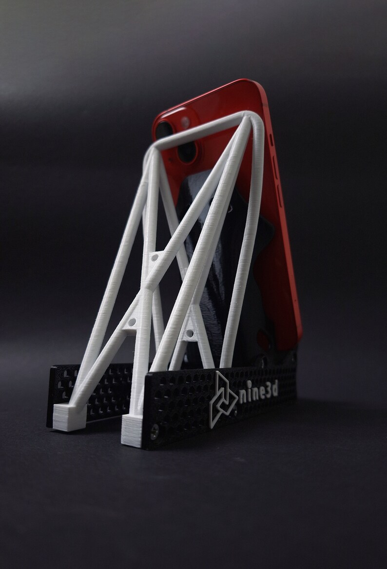 Discover the perfect blend of functionality and style with our racing seat phone holder. Ideal for motorsport enthusiasts, this 3D-printed accessory will change Your desk design and decor. Explore Nine3D shop's unique 3D-printed collection