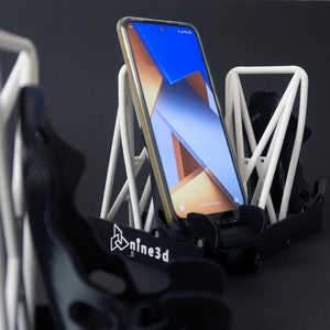 Discover the perfect blend of functionality and style with our racing seat phone holder. Ideal for motorsport enthusiasts, this 3D-printed accessory will change Your desk design and decor. Explore Nine3D shop's unique 3D-printed collection