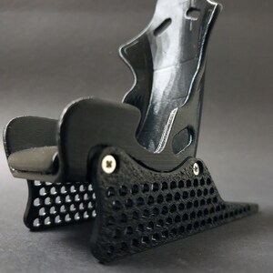 Discover the perfect blend of functionality and style with our racing seat phone holder. Ideal for motorsport enthusiasts, this 3D-printed accessory will change Your desk design and decor. Explore Nine3D shop's unique 3D-printed collection