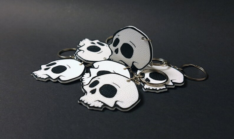 Double-sided 3D printed skull keychain made from durable PET-G material, perfect for gothic fashion lovers. Versatile accessory for both men and women. Add an edgy touch to your style. Nine3D etsy shop with highest quality prints!