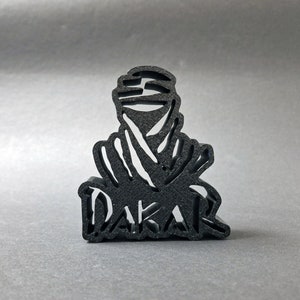 3D printed DAKAR logo stand in black, front perspective