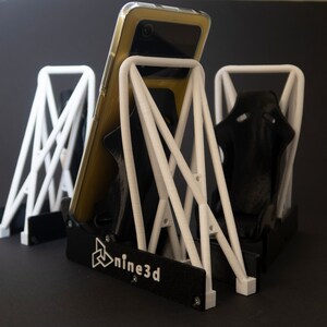 Discover the perfect blend of functionality and style with our racing seat phone holder. Ideal for motorsport enthusiasts, this 3D-printed accessory will change Your desk design and decor. Explore Nine3D shop's unique 3D-printed collection